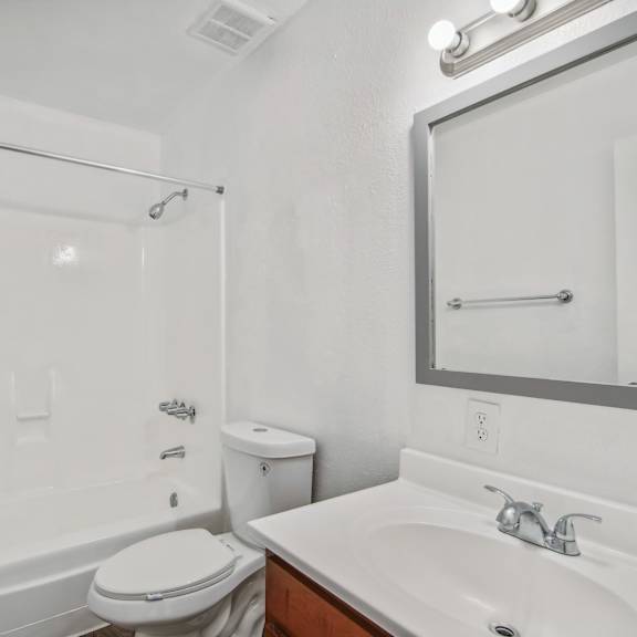 a bathroom with a sink toilet and a shower