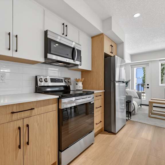 a modern kitchen with wooden cabinets and stainless steel appliances.