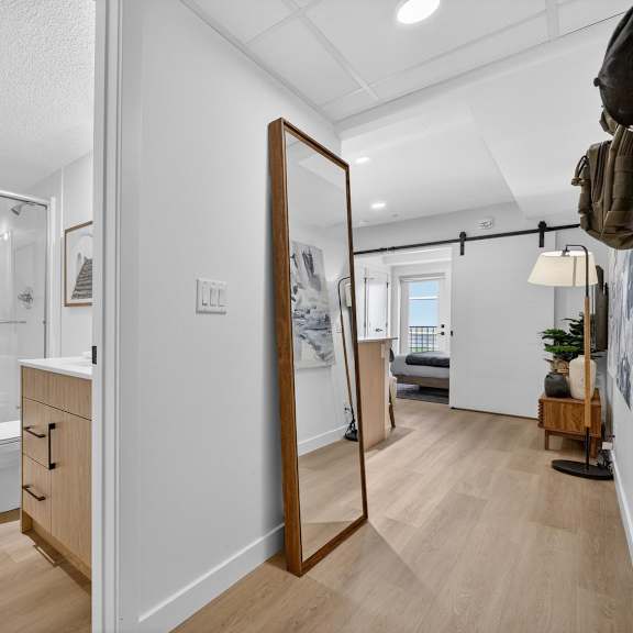 a bathroom with a toilet, sink, and mirror.