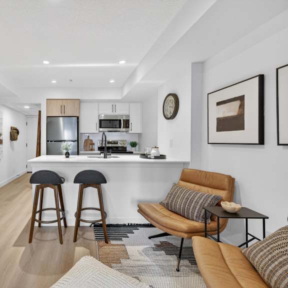 a modern living room with a bar area and a television.