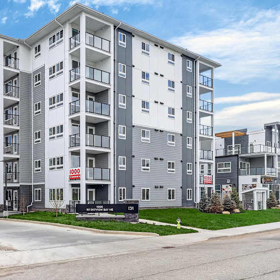 a modern apartment building with a red sign that says 1000.