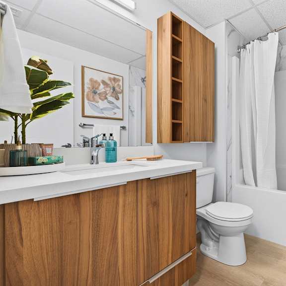 a bathroom with a toilet, sink, and bathtub.