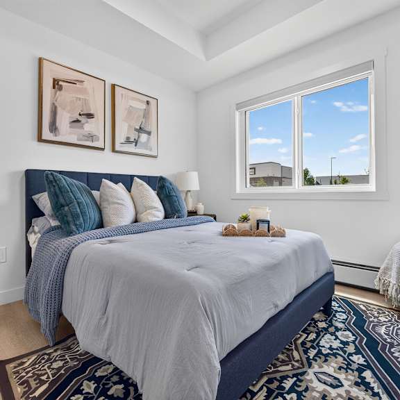a bedroom with a large bed and two pictures on the wall.