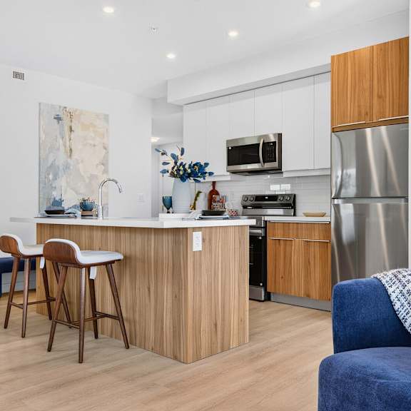a kitchen with a blue chair and a wooden table.