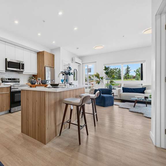 a modern kitchen with wooden cabinets and a bar area.