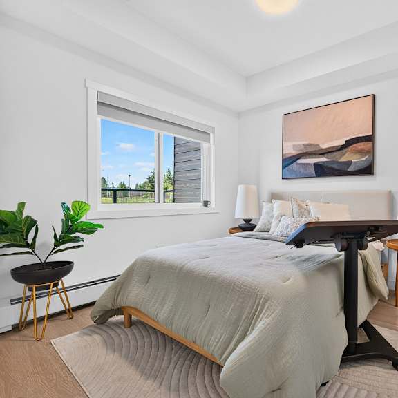 a bedroom with a large bed and a painting on the wall.