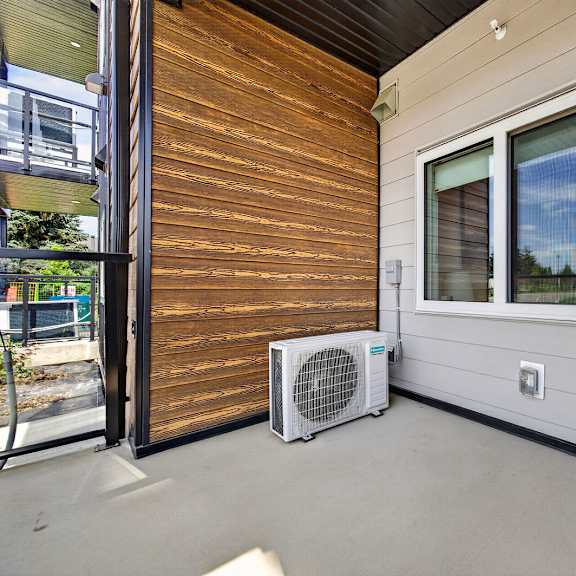 a patio with a window and a fan.