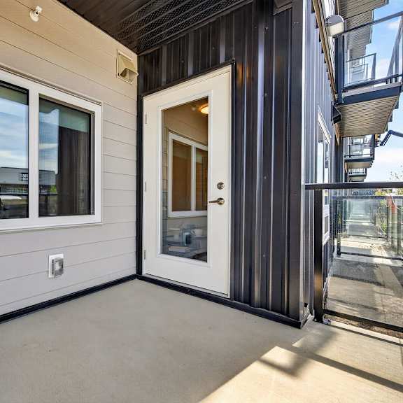 a white air conditioning unit sits on a patio.