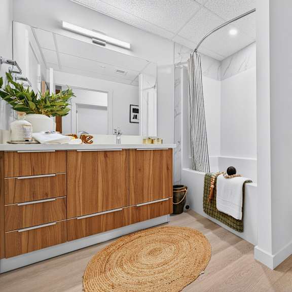 a white toilet sits next to a white sink in a bathroom.