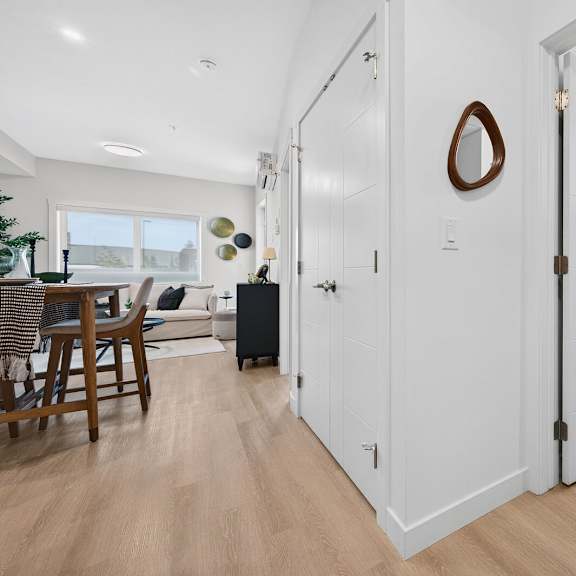 a white door with a mirror on the wall behind it.
