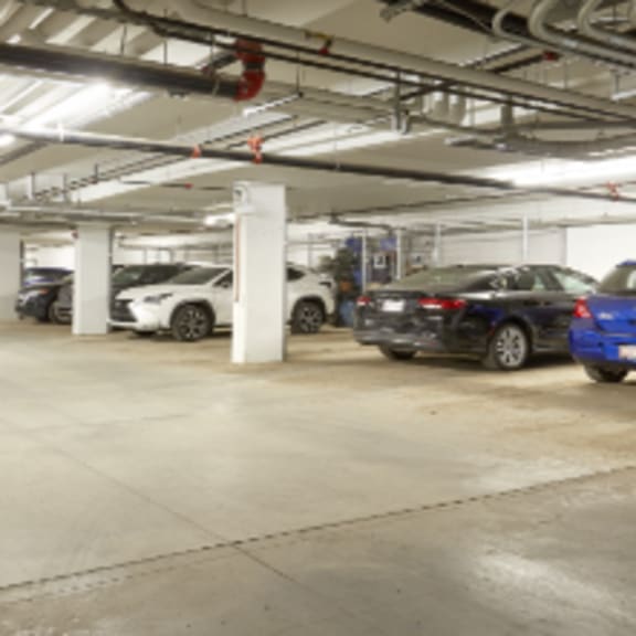 a parking garage with several cars parked.