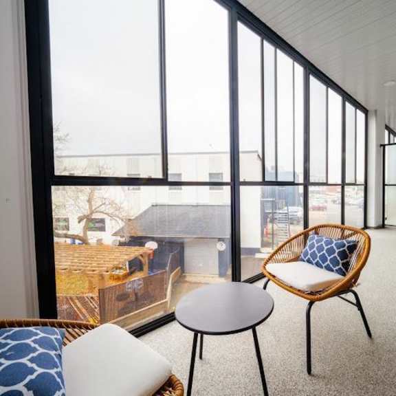 a balcony with a chair and a table.