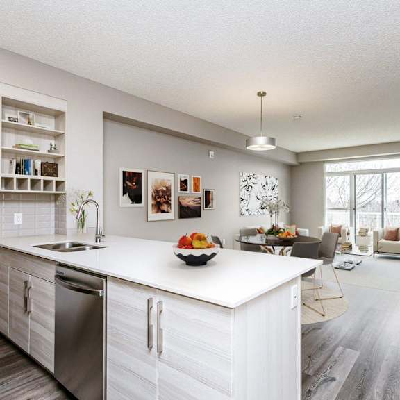 a modern kitchen with a large island and stainless steel appliances.