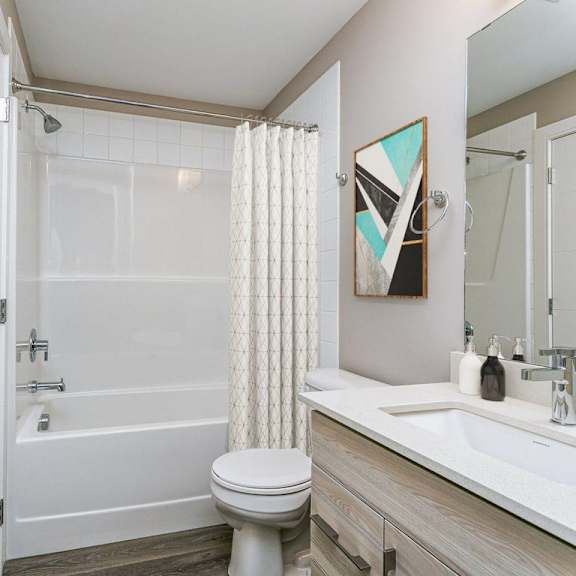 a white toilet sits next to a white sink in a bathroom.