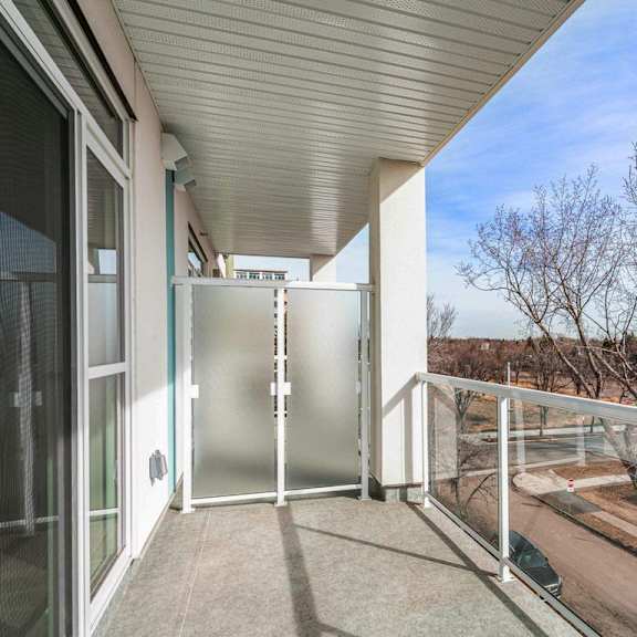 a balcony with a glass door leading to a patio.