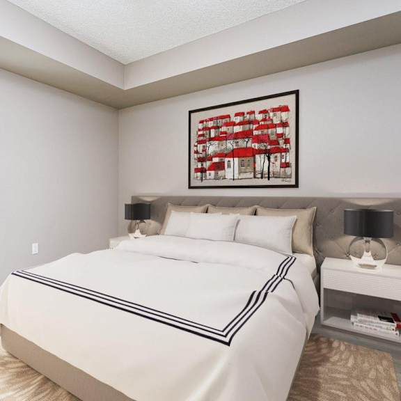 a bedroom with a large bed and a framed picture on the wall.