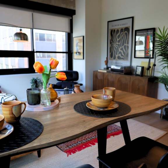 a dining table with a bowl and a cup on it.
