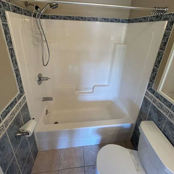 a white bathtub with a silver faucet and a silver shower head.