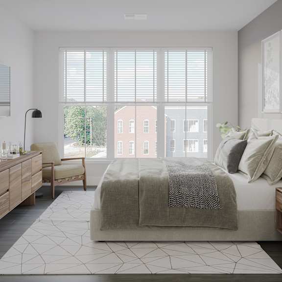 a bedroom with a bed and a large window