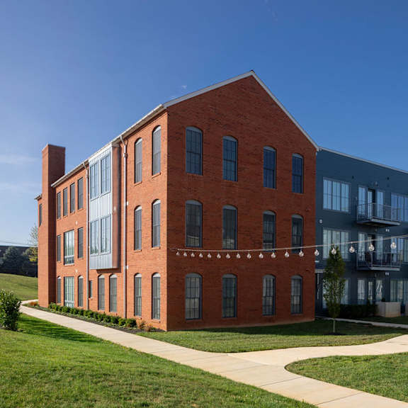 a red brick building with a walkway in front of it.