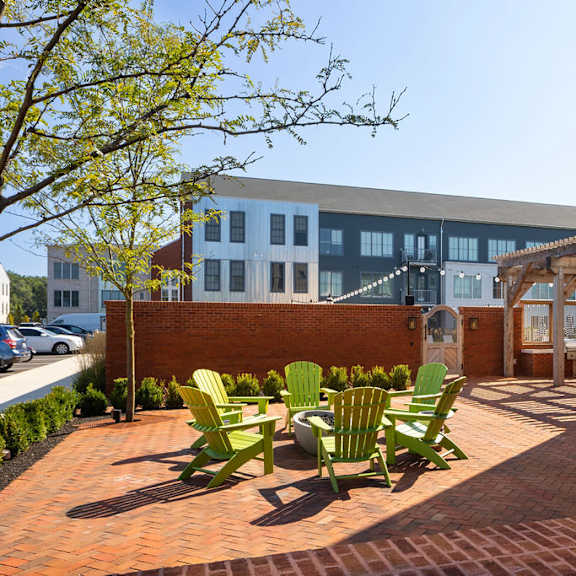 a patio with a table and chairs is in front of a building.
