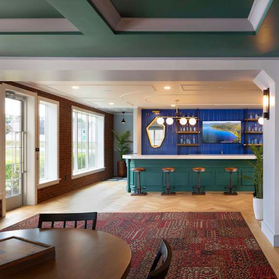 a room with a blue bar and a red rug.