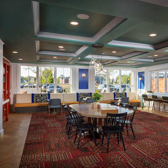 a large room with a long table and chairs.