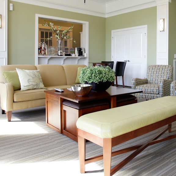 a living room with a sofa, chair, and bench.