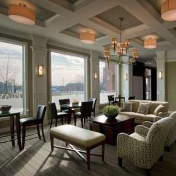 a living room with a couch, chairs, and a table.