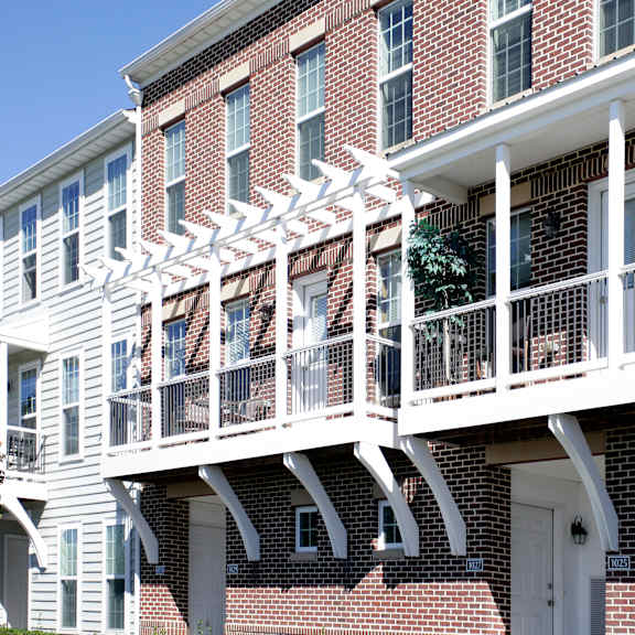 a red brick building with a white balcony.