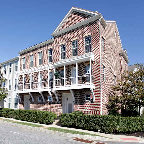 a red brick building with a white balcony.