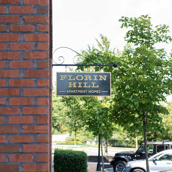 florin hill apartment homes sign on a tree.