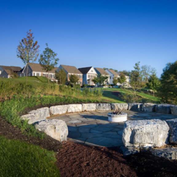 a large stone structure in the middle of a garden.