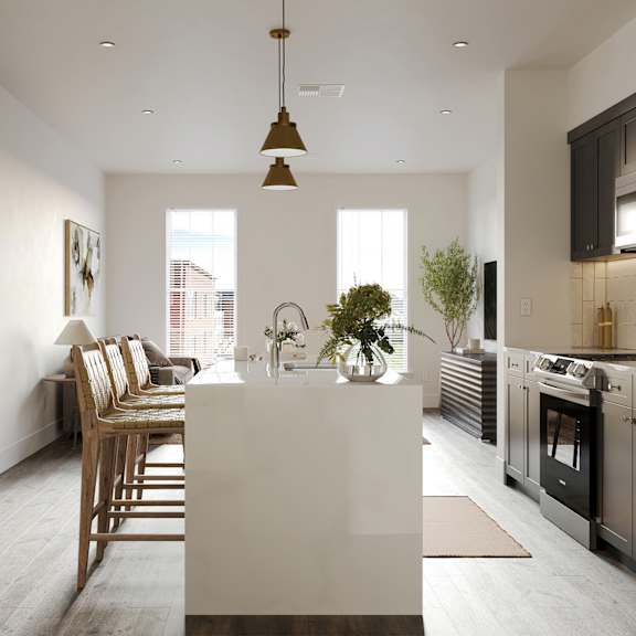 a kitchen and living room with a white island and a dining room table