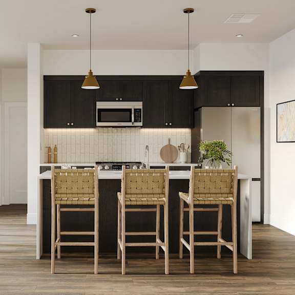 a kitchen with an island with stools in a modern apartment