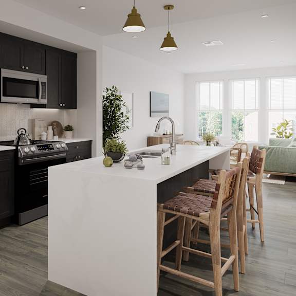 a kitchen with black cabinets and a white island with chairs