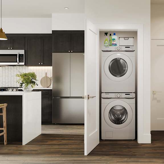 a white front loading washer and dryer in a kitchen