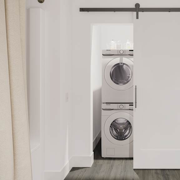 a white washer and dryer in a white closet
