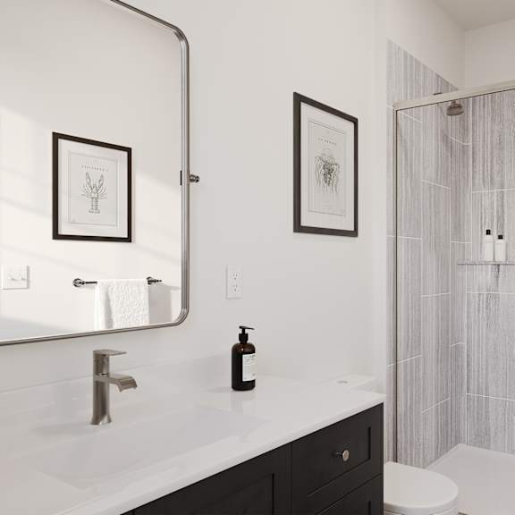 a bathroom with a shower and a sink and a mirror