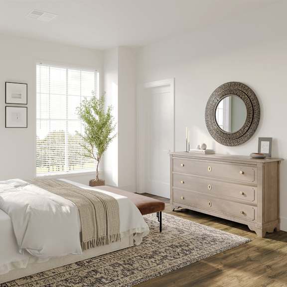 a bedroom with a bed and a dresser