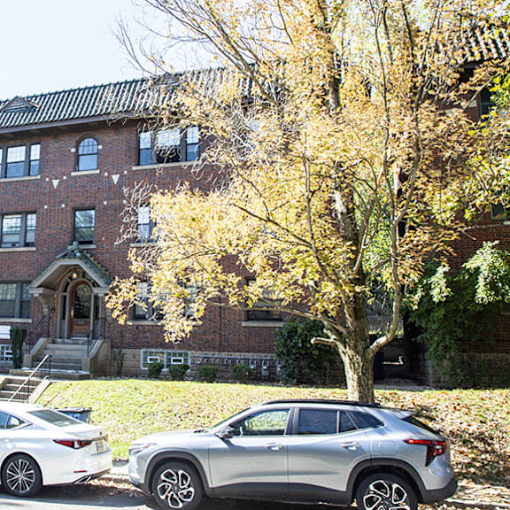 a large brick building with cars parked in front of it