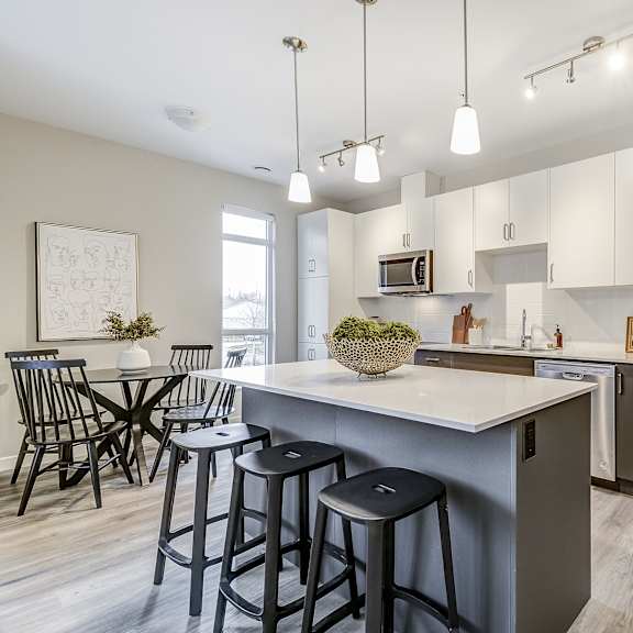 open kitchen and dining area with stainless steel appliances and bar stools  at 101 base line road west, london
