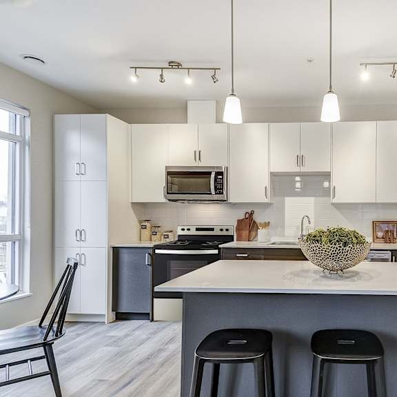 kitchen with white cabinets and a large island at 101 base line road west, london