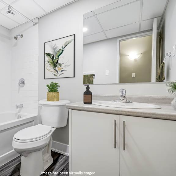 bathroom with a toilet sink and bathtub at platts crossing, london, on