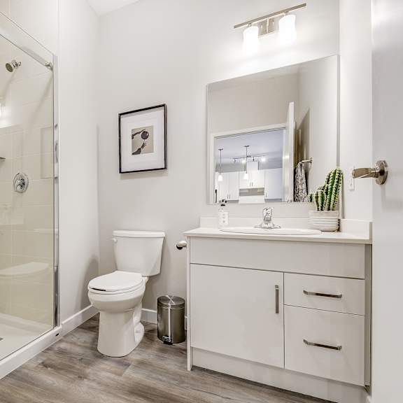 white bathroom with a shower toilet and sink  at 101 base line road west, ontario