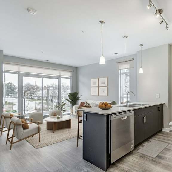 kitchen with an island and a living room with a window  at 101 base line road west, london, ontario