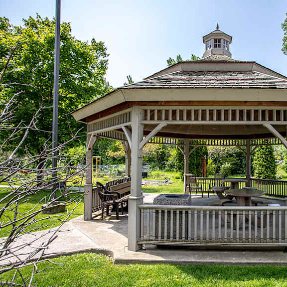 a white gazebo in a park