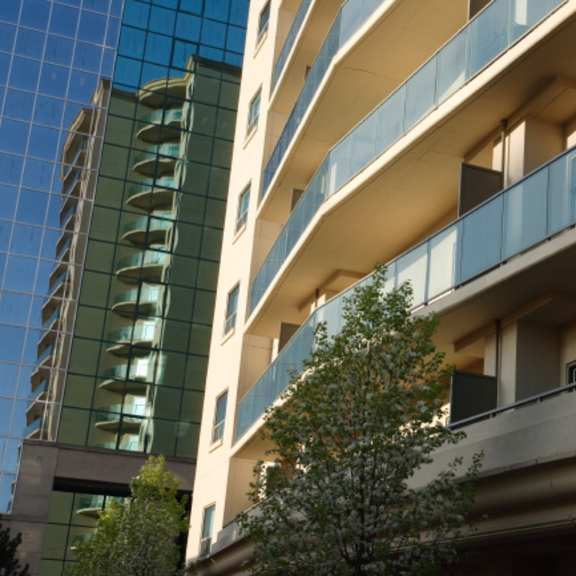 an apartment building with a tree in front of it