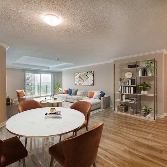 a dining area with a round table and chairs and a living room
