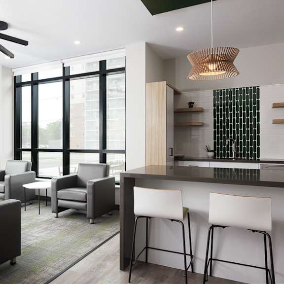 a modern living room with grey and white furniture.
